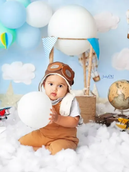 This little aviator is on cloud nine. The travel and sky theme, complete with a globe and vintage plane, is perfect for a one-year milestone session.