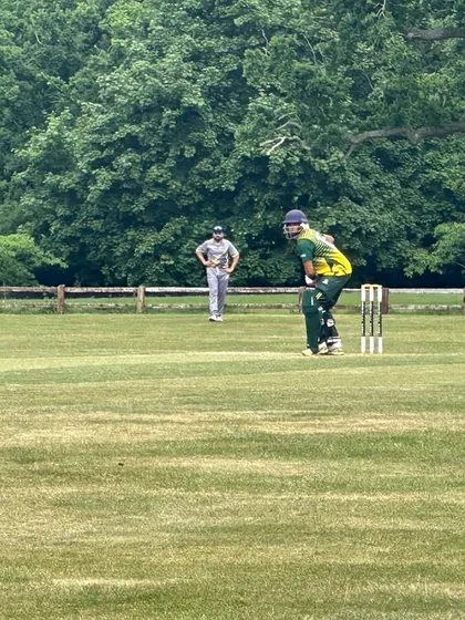 A shot of Hitesh Chauhan at the crease during his UK cricket stint. This experience of playing abroad is invaluable for building confidence and adaptability.