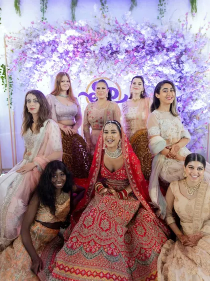 A beautiful group portrait of the bride with her bridesmaids. Their coordinated outfits and happy smiles make for a perfect memory of her bride tribe.
