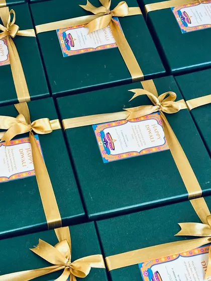 An array of our green and gold corporate Diwali hampers, showcasing our ability to handle large orders with a consistent, premium aesthetic.