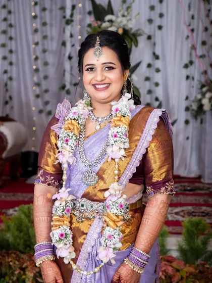A smiling portrait of Bhavya. Her makeup is designed to enhance her natural beauty and give her a special glow for her engagement.