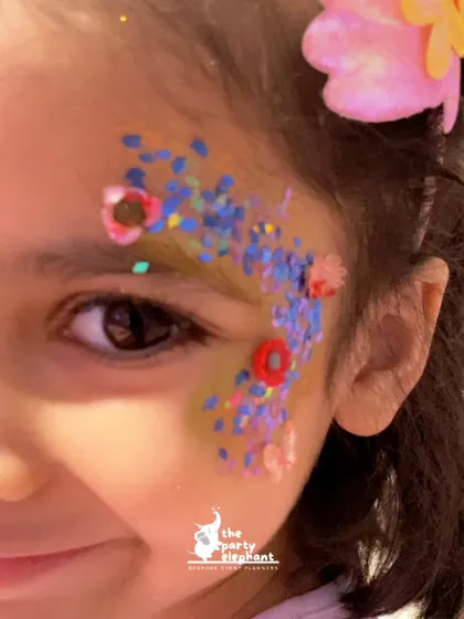 A close-up of the beautiful glitter face painting, one of our popular activities. Our artists create stunning, skin-safe designs to transform kids into little mermaids.