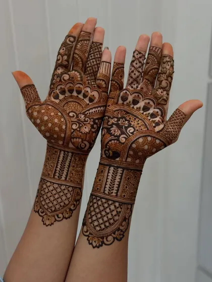 The intricacy here is just fantastic. From the detailed fingertips to the wrist cuffs, this student's work shows a comprehensive understanding of bridal mehendi design principles.