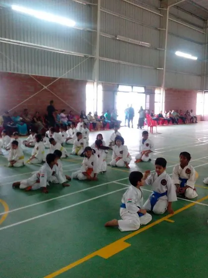 Students resting between drills during a large training session. Discipline includes knowing when to push and when to listen.