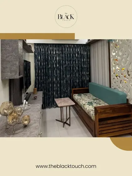 A cozy living space featuring a wooden sofa-cum-bed and a decorative partition. This is another example of our expertise in designing for compact homes.