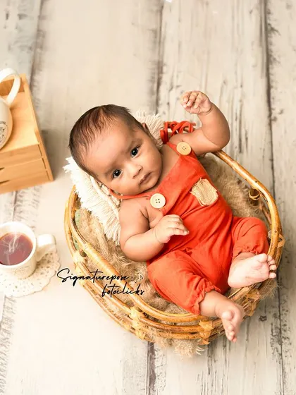 A "tea time" themed shoot for a three-month-old, with a tiny teapot and snacks.