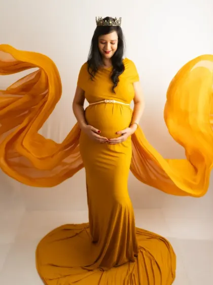 A regal portrait in a vibrant yellow gown, complete with a crown. The fabric toss creates a beautiful, wing-like effect for a dramatic touch.