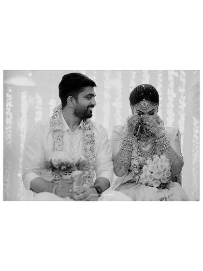 A black and white photo of Chaithanya and Abhiram during an emotional moment in their ceremony. The lack of color draws focus to their expressions and the significance of the ritual.
