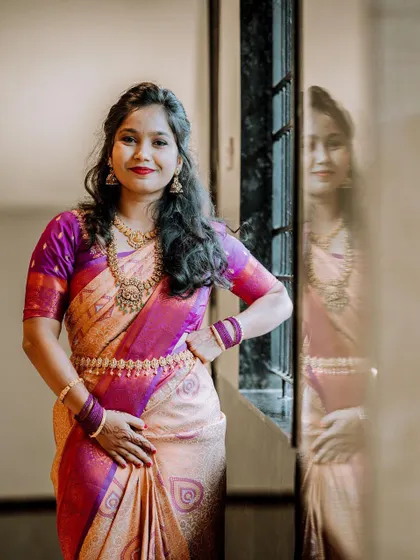 A confident and happy bridal portrait, with the bride posing with her hand on her hip.