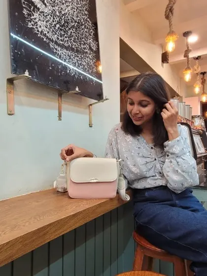 A candid moment with the Lino Perros bag. This photo shows the bag in a natural setting, highlighting its size and how it complements a relaxed yet put-together outfit.