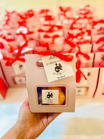 A closer look at the anniversary favor box, showing the custom silhouette tag.
