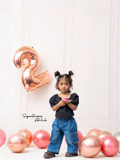 A sweet moment with a tiny cupcake to celebrate turning two. This shot is a lovely alternative to a full cake smash for older toddlers.