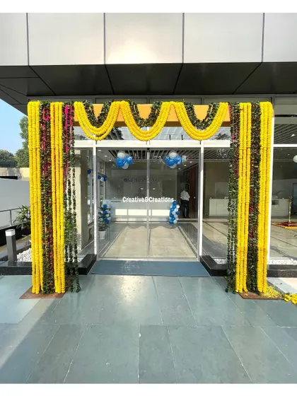 A simple yet elegant entrance decoration for a corporate office inauguration. The traditional marigold garlands provide a warm welcome.