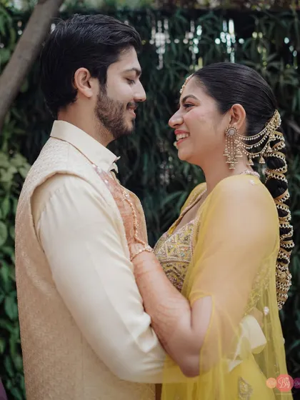 The way they look at each other says everything. A beautiful candid moment from their pre-wedding shoot in traditional yellow outfits.