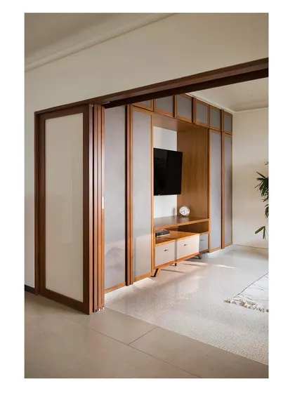 The guest bedroom and den area with its custom partition and built-in media unit. This showcases our ability to integrate storage and technology into flexible design solutions.