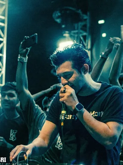 On the mic, interacting with thousands of students. My goal is to make everyone feel like they are part of the show.