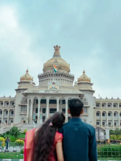 A couple looks towards the future, symbolized by the grand Vidhana Soudha before them. This is a powerful and aspirational pre-wedding portrait.