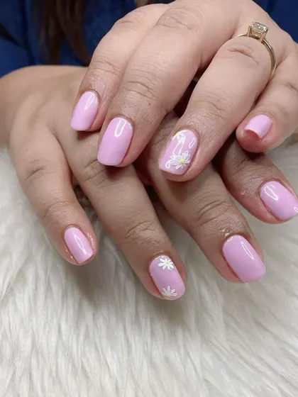 A sweet and simple pastel lavender manicure with tiny, hand-painted white daisy accents.