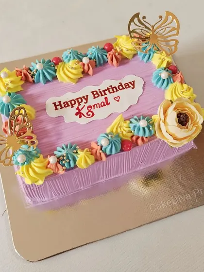 Be a pop of color in a black and white world! This rectangular cake features vibrant, multi-colored piping and gold butterflies for a fun and cheerful celebration.