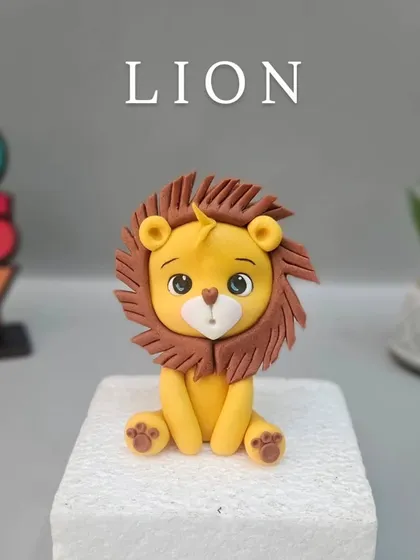 A cute fondant lion, ready to be placed on a jungle-themed cake.