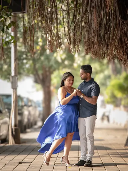 A tender moment between the couple, framed by hanging banyan tree roots. This pre-wedding photo has a natural, earthy feel that highlights their connection.