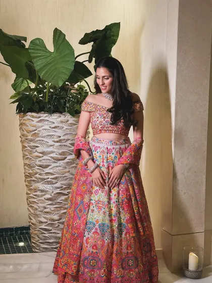 A candid moment showing the beautiful details of the Abu Jani Sandeep Khosla lehenga.