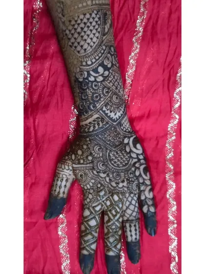 A single-hand view of a heavy, intricate design. The use of negative space around the main patterns on the back of the hand makes the artwork stand out.