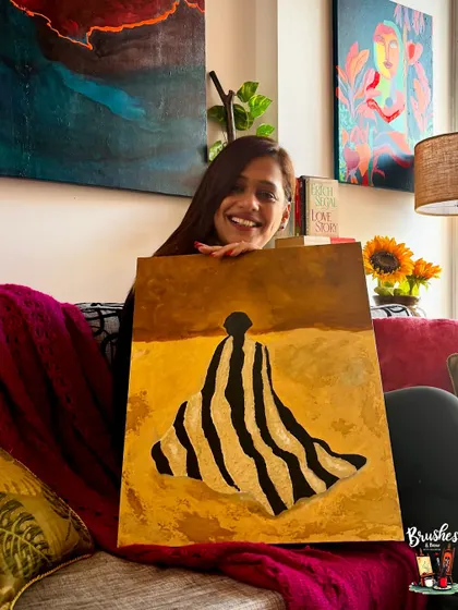 The final masterpiece! Sam proudly holding her painting, "Solace." This piece, with its rich textures and calming colors, is a perfect example of the personal and meaningful art we create in my studio.