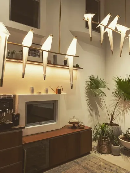 This is one of my favorite ways to blend art with function. For this office pantry, I used these beautiful bird-shaped decorative lights to create a striking visual centerpiece. This is balanced with integrated joinery lighting under the shelf, which provides perfect, shadow-free light for the task area below.