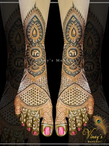 A designer feet mehndi with intricate patterns and elephant motifs. The shading and line work are exceptionally detailed, creating a 3D effect.