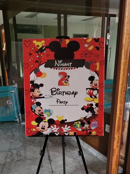 A custom Mickey Mouse welcome board on an easel, perfect for greeting guests at the party entrance.