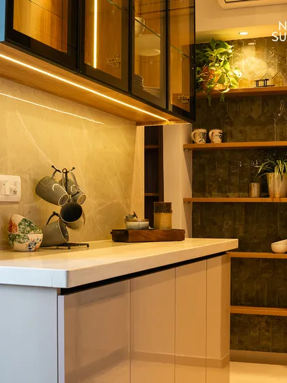 We designed this kitchen with a mix of closed cabinets and open shelving. The open shelves, set against a dark, textured backsplash, provide a space for displaying decor and keeping everyday items within reach.