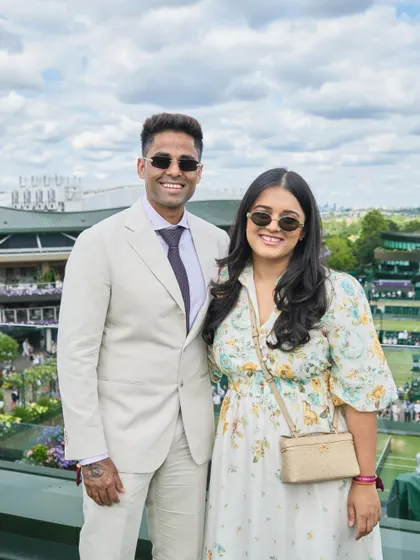 A great shot of Suryakumar Yadav and his wife at Wimbledon. His light-colored suit is a perfect choice for a daytime event, looking fresh and stylish against the iconic backdrop.