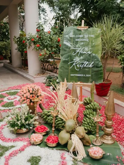 A warm, traditional welcome for a beautiful Tamil wedding. We designed this entrance using a custom acrylic sign on a banana leaf, surrounded by fresh flowers, coconuts, and brass lamps to create an authentic cultural greeting.