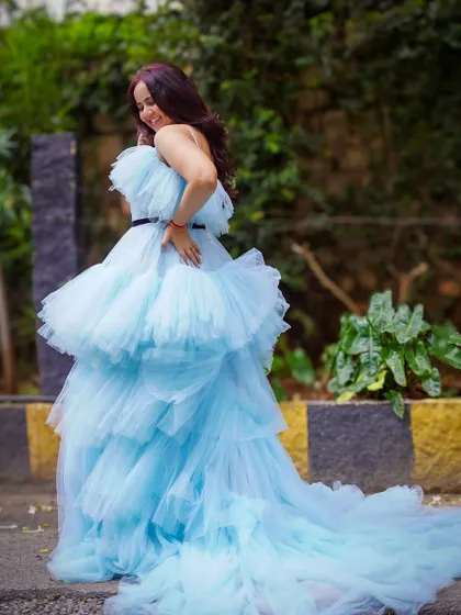 This sky blue tiered ruffle gown with a long trail is a true fairytale dress. It's perfect for photoshoots, receptions, or any event where you want to feel like a princess.