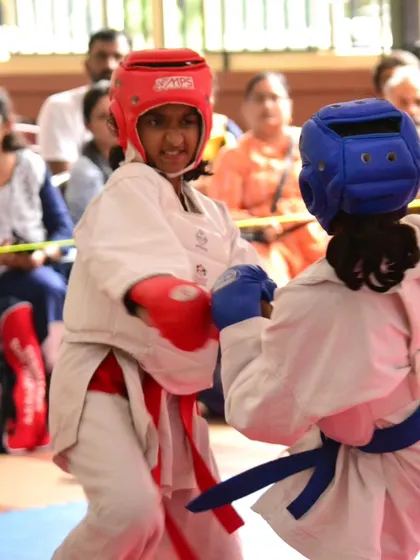 Two young girls compete with intensity and respect during a kumite match. We teach our students that sportsmanship is just as important as winning.