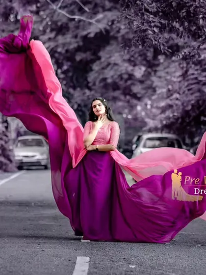 The pink and purple flying gown is captured in full flight, showing the incredible wing-like shape the fabric can create.