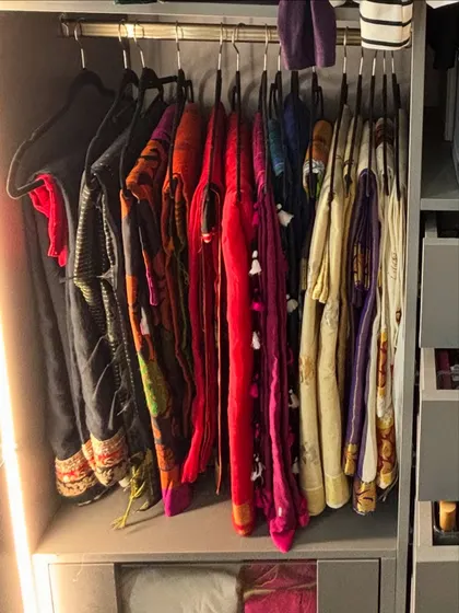 A collection of sarees hung neatly, showcasing their vibrant colors and patterns. This method is ideal for sarees that are worn more frequently.
