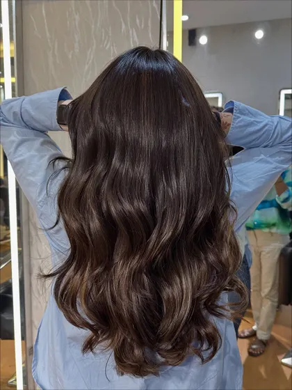 The client showing off her new Chocolate Mocha Brown hair. The color is vibrant and makes her hair look incredibly healthy.