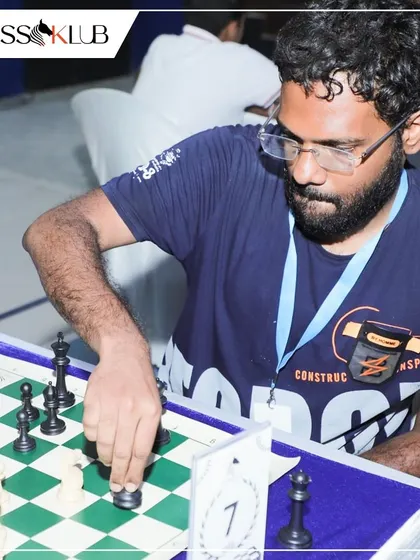 A close-up of a player making a critical move during the KSCA and BUDCA event, capturing the intensity of high-level chess.