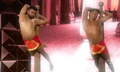 Two of our artists performing synchronized poses during the 'Lo Show Dei Record' performance. The aesthetics and symmetry of the movements are a key part of what makes Mallakhamb so captivating to watch.