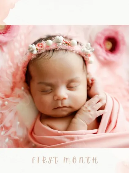 A close-up portrait capturing the delicate features of a newborn in her first month. The soft pink swaddle and floral headband complement her peaceful expression perfectly.