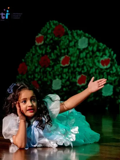 Alice lies on stage, dreaming at the beginning of her adventure. The lead roles are performed with remarkable poise and expression.