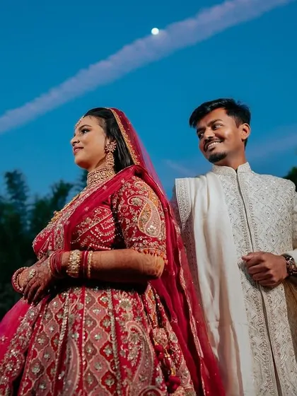 A regal bride in her magnificent red lehenga. We capture the grandeur of the bridal attire, creating portraits that are both powerful and elegant.