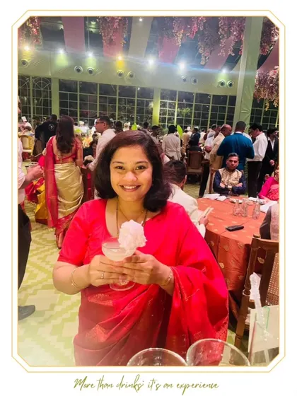 A guest enjoying our whimsical cotton candy cocktail. The fluffy garnish not only looks great but also dissolves into the drink, adding sweetness and a touch of fun.