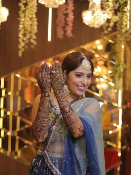Our client showing off her beautiful mehendi in our navy blue sequin lehenga.