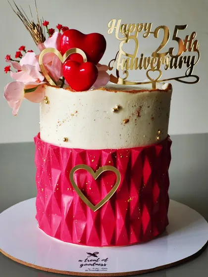 This popular design was requested again by a client for a 25th anniversary. The two-tiered cake features a geometric texture on the bottom and a smooth, speckled top, tied together with red and gold hearts.