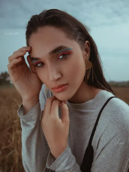 A close-up from the 'UTOPIA' series, focusing on the graphic eyeliner and wet-look hair.
