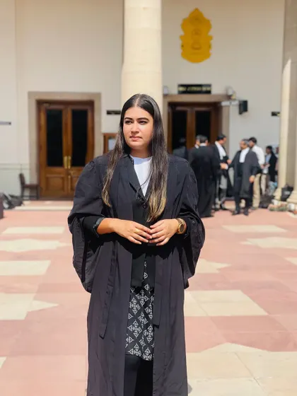 Standing in my robes at the Supreme Court. It is an honor to practice here and represent clients at the apex court.