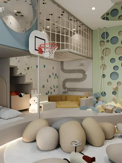 We turned this room into an indoor playground with a netted loft area, a mini basketball hoop, and a soft ball pit. The design proves that even with a bed and storage, there's always room for fun.